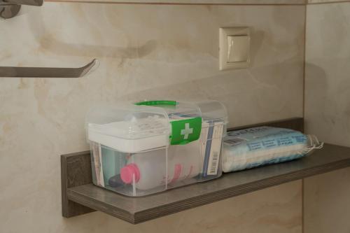 a shelf in a bathroom with a box on it at F & A Family Home in Zarós