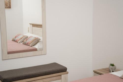 a mirror reflection of a bed in a bedroom at F & A Family Home in Zarós