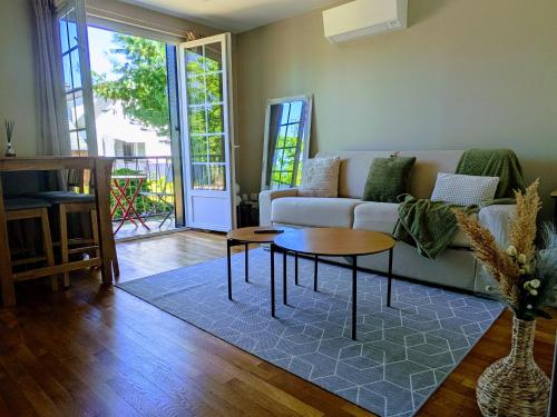 a living room with a couch and a table at Plaisance in Saint-Satur