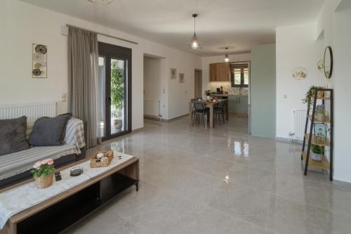 a living room with a couch and a table at F & A Family Home in Zarós