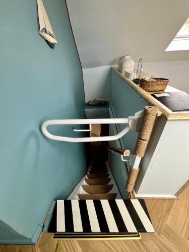 a spiral staircase in a room with a blue wall at The Blue Loft in Anstruther