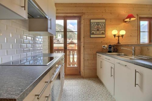 a kitchen with a sink and a counter top at Chalet Eden, 4 Story Family Chalet in Champéry