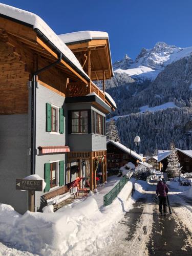 a man standing in the snow in front of a building at Chalet Eden, 4 Story Family Chalet in Champéry