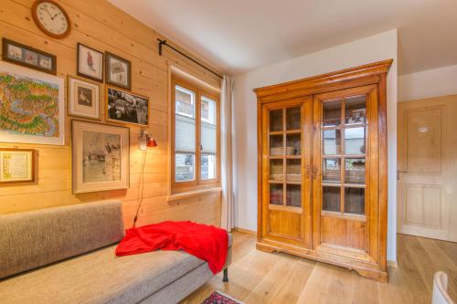 a room with a bench and a clock on the wall at Chalet Eden, 4 Story Family Chalet in Champéry