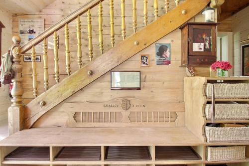 a staircase in a log home with a wooden stair case at Chalet Eden, 4 Story Family Chalet in Champéry