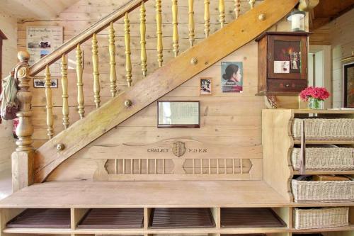 a staircase in a log home with a wooden wall at Chalet Eden, 4 Story Family Chalet in Champéry