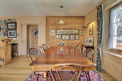 a dining room with a wooden table and chairs at Chalet Eden, 4 Story Family Chalet in Champéry