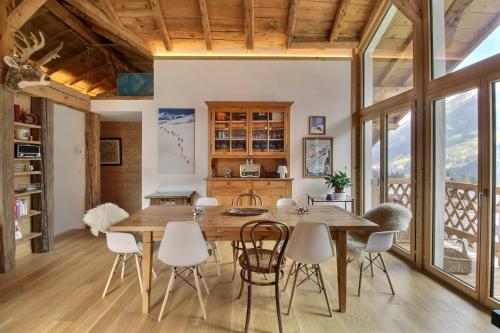 a dining room with a wooden table and chairs at Chalet Eden, 4 Story Family Chalet in Champéry