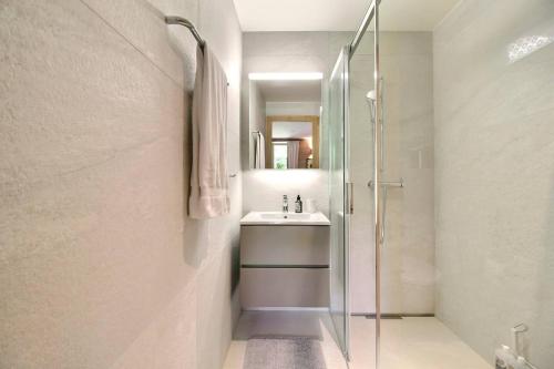 a bathroom with a glass shower and a sink at Chalet Eden, 4 Story Family Chalet in Champéry