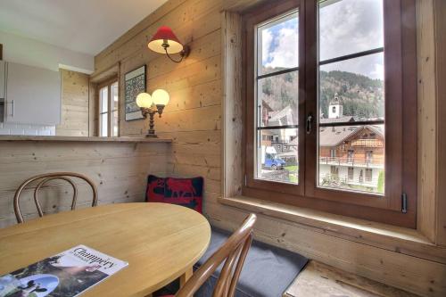 a dining room with a table and a window at Chalet Eden, 4 Story Family Chalet in Champéry