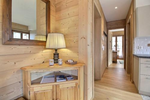 a room with wooden walls and a table with a lamp at Chalet Eden, 4 Story Family Chalet in Champéry
