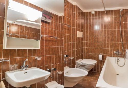 a bathroom with a toilet and a sink at Chesa Sarvit 1 - Celerina in Celerina