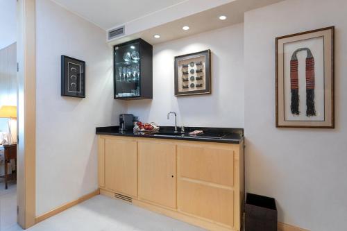 a kitchen with a sink and a counter at Suites del Mar Fenals Apartments in Lloret de Mar
