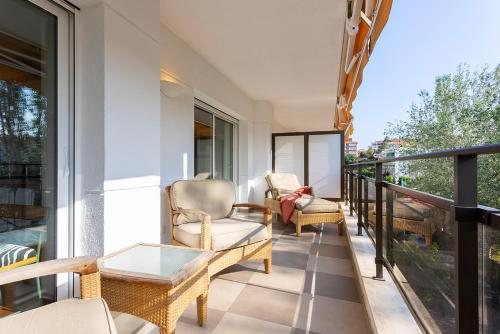 a balcony with two chairs and a table at Suites del Mar Fenals Apartments in Lloret de Mar