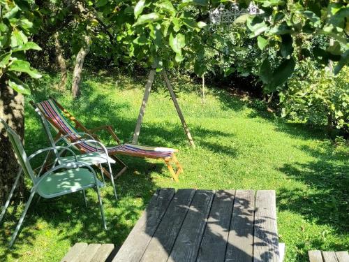 a group of chairs sitting in the grass in a garden at Naturparadies am Sonntagberg in Sonntagberg