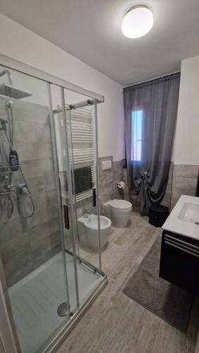 a bathroom with a shower and a toilet and a sink at Casa Morena in Montecarlo