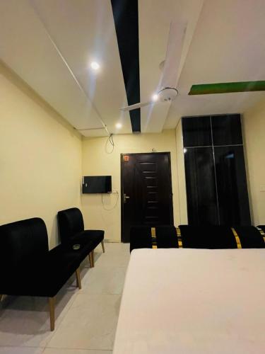 a conference room with a table and chairs and a door at Hayat Lodges & Hotel in Lahore