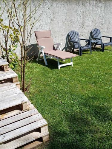 two chairs and a picnic table in the grass at Gîtes L'Evasion Thudinienne in Thuin