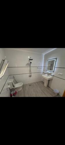 a bathroom with two toilets and a sink and a mirror at Appartement quartier marsa al hoceima 1 in Al Hoceïma