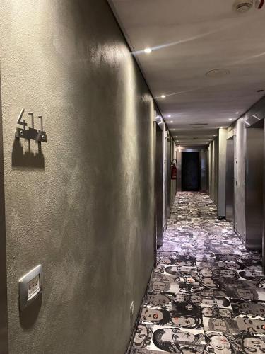a hallway with a tile floor in a building at CAVALLO Hotel Noventa di Piave in Noventa di Piave