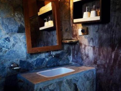 a bathroom with a sink and a mirror at Mati Gedara Resort in Digana