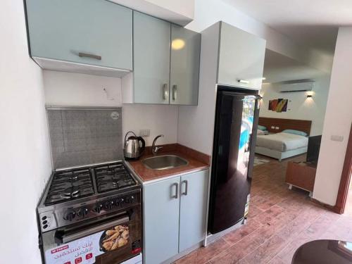 a small kitchen with a stove and a sink at Family Chalet Pool & Aqua-Park Access in Sharm El Sheikh in Sharm El Sheikh