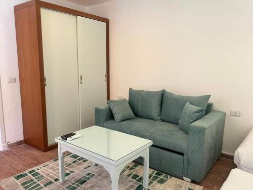 a living room with a couch and a coffee table at Family Chalet Pool & Aqua-Park Access in Sharm El Sheikh in Sharm El Sheikh