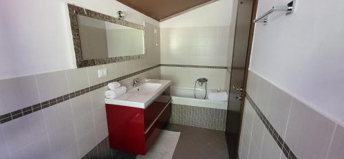 a bathroom with a sink and a mirror and a tub at Villa Tiziana in Podenzana