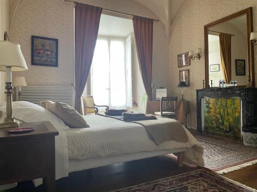 a bedroom with a large bed and a large window at Guest-House Château de Longecourt en Plaine in Longecourt-en-Plaine