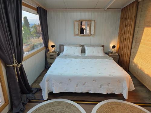 a bedroom with a large bed and a large window at Guest House Megdani in Ohrid