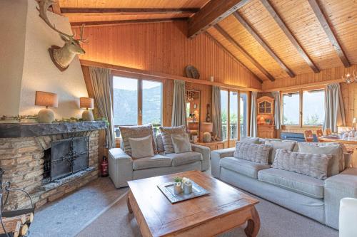 a living room with a couch and a fireplace at Le Petit Renard MOUNTAIN & QUIET 7 pers in Vex