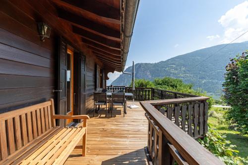a wooden balcony of a house with a table and chairs at Le Petit Renard MOUNTAIN & QUIET 7 pers in Vex