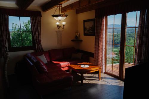a living room with a couch and a table at Brioni Hills - Premium Escape in Šmarje pri Jelšah