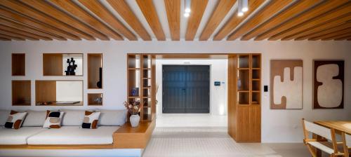 a living room with a couch and a blue door at Acrodise Estate in Santorini