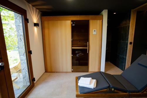 a view of a room with a chair and a mirror at Brioni Hills - Premium Escape in Šmarje pri Jelšah