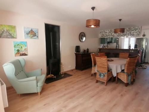 a living room with a dining room table and chairs at Maison champêtre à Gavray-sur-Sienne avec jardin clôturé in Gavray