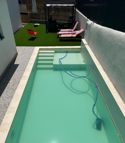 a swimming pool with a hose in a building at Vivenda Branca Martinho I in Peso da Régua