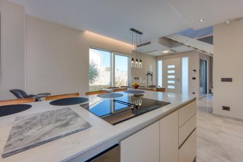 a kitchen with a island with a glass counter top at Villa Rosciola in Crikvenica