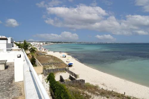 a view of a beach with people in the water at Villa Layla on the beach in Torre Lapillo