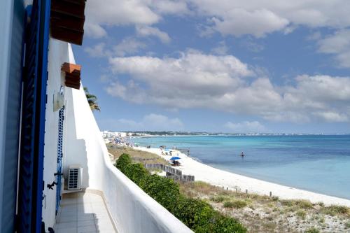 a view of a beach and the ocean from a building at Villa Layla on the beach in Torre Lapillo