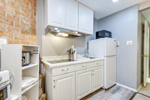 a kitchen with white cabinets and a white refrigerator at Less Than 25 Mi to Downtown Baltimore and DC Apt with Deck in Columbia