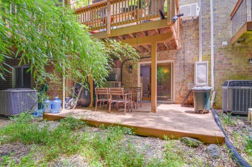 a patio with a wooden table and a deck at Less Than 25 Mi to Downtown Baltimore and DC Apt with Deck in Columbia