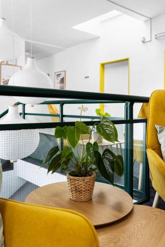 a potted plant sitting on a table on a balcony at Penzion Village Peace #29 by Goodnite cz - U Libušky in Brno