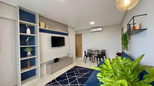 a living room with a tv and a dining room at (1209)Studio com vista panorâmica mar in São Luís