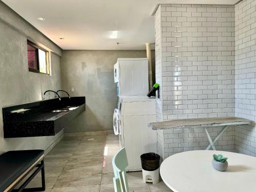 a kitchen with a sink and a table in it at (1209)Studio com vista panorâmica mar in São Luís