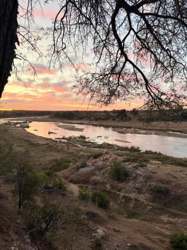 a view of a river at sunset at Veni Vidi Amavi Luxury Safari Treehouse in Marloth Park