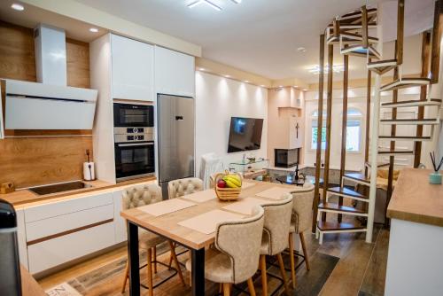 a kitchen and dining room with a wooden table and chairs at NS Villa Kastrosykia in Pídima Kyrás