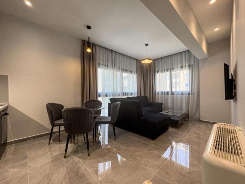 a living room with a couch and a table and chairs at VILLA 8 By ProLiving Hospitality in Thessaloniki