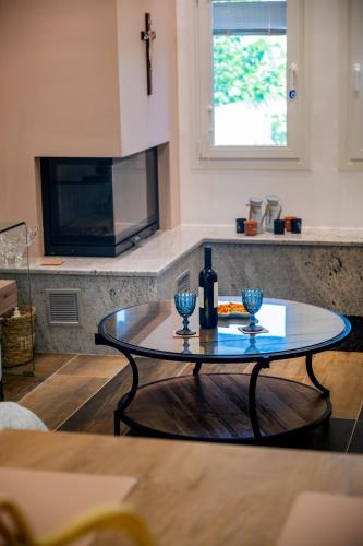 a table with two wine glasses on it in a kitchen at NS Villa Kastrosykia in Pídima Kyrás