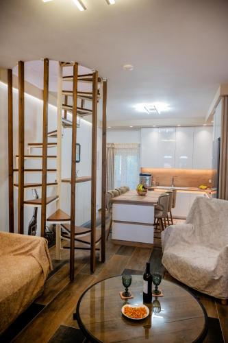 a living room with a loft bed and a kitchen at NS Villa Kastrosykia in Pídima Kyrás